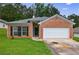 Charming single-story home with a brick facade, a two-car garage, and a well-maintained lawn at 10247 Deep Creek Pl, Union City, GA 30291