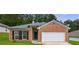 Charming one-story brick home with a well-manicured lawn and an attached two-car garage at 10247 Deep Creek Pl, Union City, GA 30291