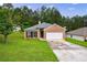 Charming single-story home with a brick facade, a two-car garage, and a well-maintained lawn at 10247 Deep Creek Pl, Union City, GA 30291