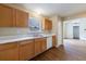 Eat-in kitchen featuring wood cabinets, laminate floors, and stainless dishwasher at 10247 Deep Creek Pl, Union City, GA 30291
