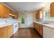 Kitchen featuring wooden cabinets, double windows, and a door to the outside at 10247 Deep Creek Pl, Union City, GA 30291