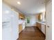 Bright kitchen with wooden cabinets, white appliances, and wood-look flooring at 10247 Deep Creek Pl, Union City, GA 30291