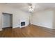 Spacious living room featuring a fireplace, ceiling fan, and hardwood floors at 10247 Deep Creek Pl, Union City, GA 30291