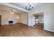 A spacious living room connects to the kitchen and features a fireplace, ceiling fan, and hardwood floors at 10247 Deep Creek Pl, Union City, GA 30291