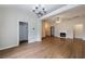 Spacious living room with hardwood floors, fireplace and modern light fixture at 10247 Deep Creek Pl, Union City, GA 30291