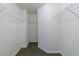 Walk-in closet with white walls, shelves and gray carpet flooring at 10247 Deep Creek Pl, Union City, GA 30291