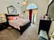 Bright bedroom with a decorative window, carpet floors and a comfortable queen size bed at 1902 Commons View Cir, Snellville, GA 30078