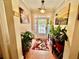 Inviting entryway with hardwood floors, a colorful rug, a glass panel door, and potted plants at 1902 Commons View Cir, Snellville, GA 30078