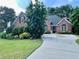 Inviting brick home with a well-manicured lawn and a spacious driveway at 1902 Commons View Cir, Snellville, GA 30078