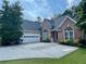 Lovely brick home with an attached garage, beautiful windows and a manicured lawn at 1902 Commons View Cir, Snellville, GA 30078