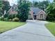 Inviting brick home with lush landscaping, well-manicured lawn, and a spacious driveway at 1902 Commons View Cir, Snellville, GA 30078