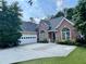 Lovely brick home featuring an attached garage and manicured lawn at 1902 Commons View Cir, Snellville, GA 30078