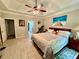 Main bedroom featuring a tray ceiling, tile floors, and a comfortable queen size bed at 1902 Commons View Cir, Snellville, GA 30078