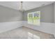 Light-filled dining room featuring a chandelier and a large window with views of the outdoors at 4092 Arabian Way, Snellville, GA 30039