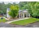 Charming home featuring a cozy front porch, manicured lawn, and lush, mature trees at 4092 Arabian Way, Snellville, GA 30039