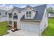 View of a two-story home showcasing the attached two-car garage and a well-maintained lawn at 4092 Arabian Way, Snellville, GA 30039