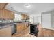 Modern kitchen featuring an island, wooden cabinets, stainless steel appliances, and hardwood floors at 4092 Arabian Way, Snellville, GA 30039