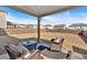 Covered back patio with comfortable outdoor seating overlooking a large backyard space at 90 Citrine Way, Acworth, GA 30101