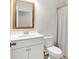 Well-lit bathroom featuring a framed mirror, white cabinets, and a toilet with a shower/tub combo at 90 Citrine Way, Acworth, GA 30101