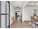 Bright entryway with hardwood floors, modern chandelier and views into the living spaces at 90 Citrine Way, Acworth, GA 30101