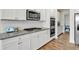 Modern kitchen featuring granite countertops, stainless steel appliances, and white cabinetry at 90 Citrine Way, Acworth, GA 30101