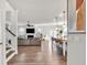 Open concept living space with hardwood floors, modern kitchen, and a cozy fireplace at 90 Citrine Way, Acworth, GA 30101