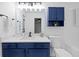 Bathroom featuring a blue vanity, tub and shower combination, and modern fixtures at 132 Timber Mist Ln, Lawrenceville, GA 30045