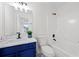 Bathroom featuring a blue vanity, tub and shower combination, and modern fixtures at 132 Timber Mist Ln, Lawrenceville, GA 30045