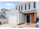 Charming home with gray siding, black shutters, a one car garage, and a brick entrance at 132 Timber Mist Ln, Lawrenceville, GA 30045