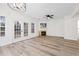 Bright living room featuring a large bay window, wood floors, a fireplace, and a ceiling fan at 132 Timber Mist Ln, Lawrenceville, GA 30045