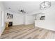 Bright, open-concept living space featuring wood floors, fireplace, and modern lighting fixtures at 132 Timber Mist Ln, Lawrenceville, GA 30045