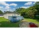 Backyard view showcasing a wooden deck, green lawn and a fire pit area, perfect for outdoor gatherings at 511 Reid St, Villa Rica, GA 30180