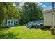 Backyard featuring a shed with a seating area and grill at 511 Reid St, Villa Rica, GA 30180