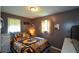 A sunflower-themed bedroom features two windows, a dresser, and dark gray walls at 511 Reid St, Villa Rica, GA 30180