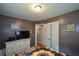 Bedroom with a sunflower-themed bedspread, white dresser, and gray accent wall at 511 Reid St, Villa Rica, GA 30180