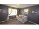 Cozy bedroom featuring neutral walls, carpet floors, and natural light from the window at 511 Reid St, Villa Rica, GA 30180