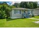 Cozy single-story house featuring a well-manicured lawn and inviting front porch at 511 Reid St, Villa Rica, GA 30180