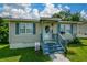 Charming home with a covered entrance, blue trim, and a lush green lawn at 511 Reid St, Villa Rica, GA 30180