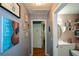 Hallway showcasing artwork, leading to a bathroom with shelving and decor at 511 Reid St, Villa Rica, GA 30180