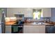 This kitchen features white cabinets, stainless steel appliances, and a double basin sink at 511 Reid St, Villa Rica, GA 30180