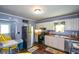 A bright kitchen with white cabinets, stainless steel appliances, and sunflower decor throughout at 511 Reid St, Villa Rica, GA 30180