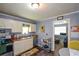 A kitchen area adjacent to the living room, equipped with stainless steel appliances and white cabinetry at 511 Reid St, Villa Rica, GA 30180