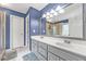 Well-lit bathroom with double sink vanity, glass door shower, and tile flooring at 530 Georgian Hills Dr, Lawrenceville, GA 30045