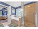 Bathroom featuring a soaking tub with decorative window, glass enclosed shower, and open doorway at 530 Georgian Hills Dr, Lawrenceville, GA 30045