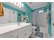 Bathroom features white cabinets, a large mirror, and teal colored walls at 530 Georgian Hills Dr, Lawrenceville, GA 30045