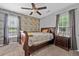 Bedroom features a wooden accent wall, neutral carpet, and window views at 530 Georgian Hills Dr, Lawrenceville, GA 30045