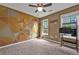 Bedroom with a colorful accent wall and a ceiling fan at 530 Georgian Hills Dr, Lawrenceville, GA 30045