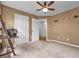 A bedroom with a ceiling fan, carpeted floors, and two closets at 530 Georgian Hills Dr, Lawrenceville, GA 30045