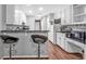 A kitchen with counter seating, stainless appliances, white cabinets, and a black countertop at 530 Georgian Hills Dr, Lawrenceville, GA 30045