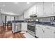 A kitchen with stainless appliances, white cabinets, and a mosaic backsplash at 530 Georgian Hills Dr, Lawrenceville, GA 30045
